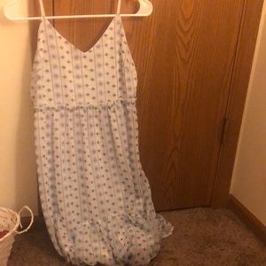 a white dress with blue design.